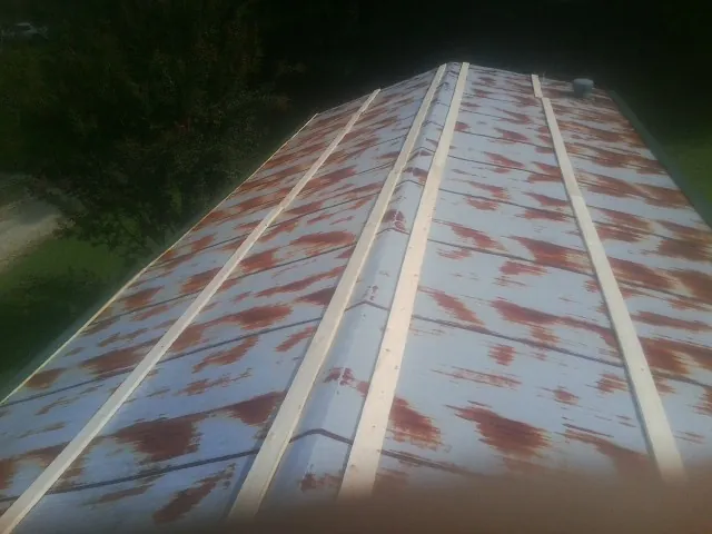 Rusted metal roof panels with new wood purlins before replacement — Storm Damage Roof Repair in Garibaldi by Roofing Brothers