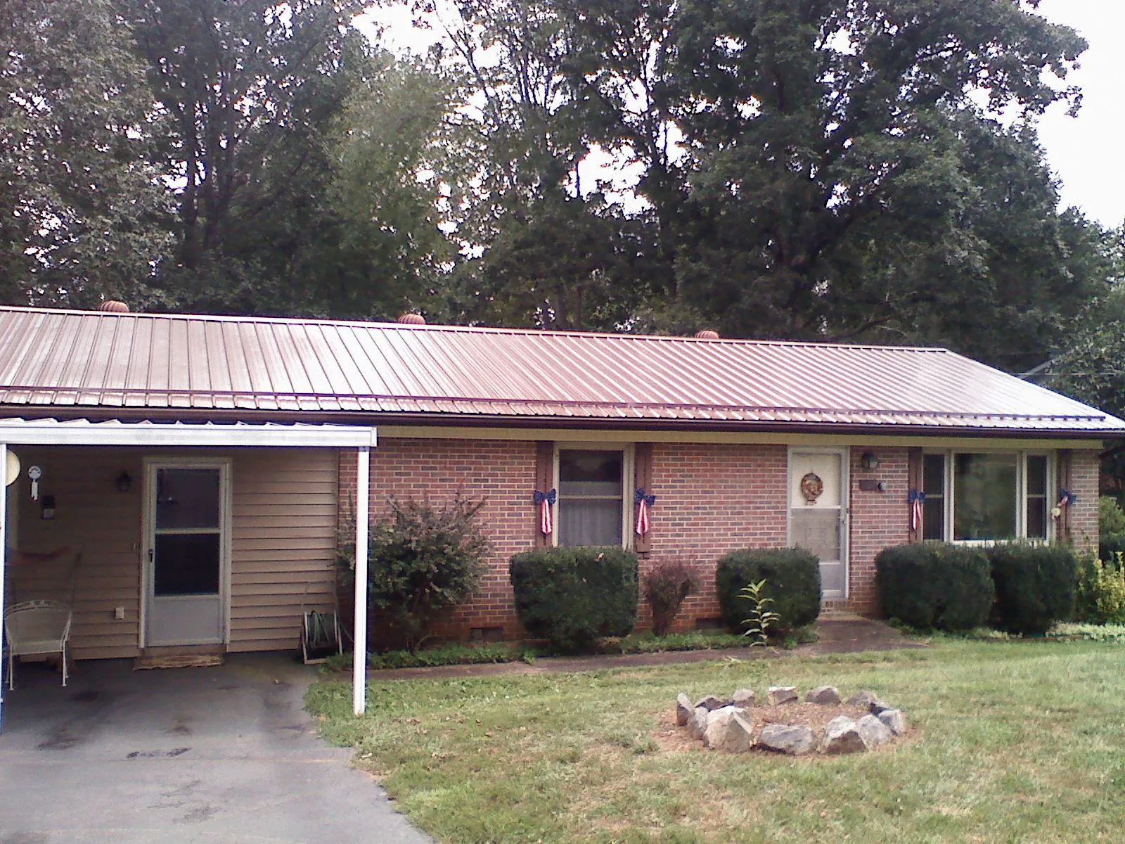 Bronze metal roof and carport on a brick ranch home — Roof Repair work by our crew in Garibaldi